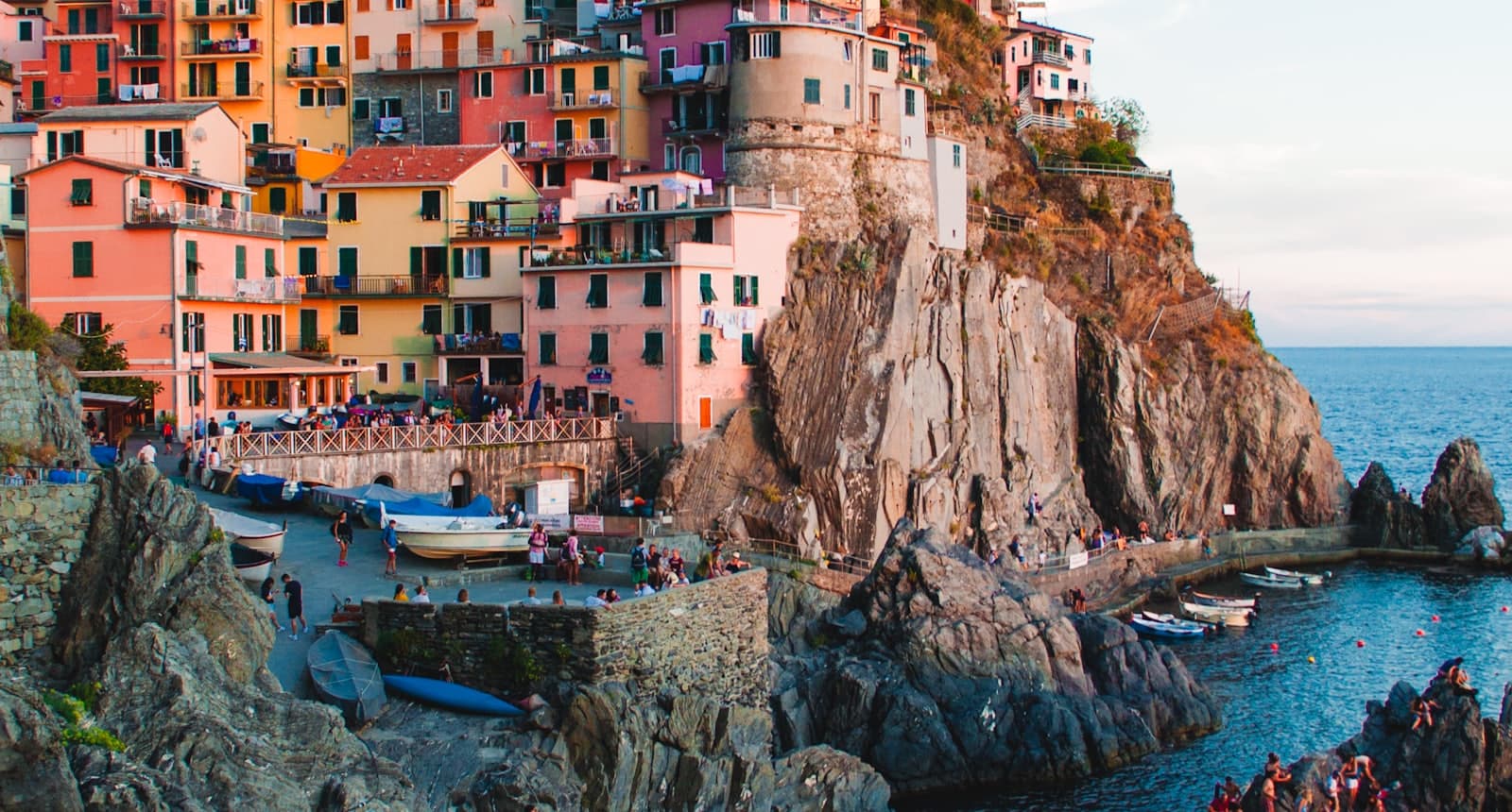 A thriving coastal port town built into cliffs above a busy harbour.